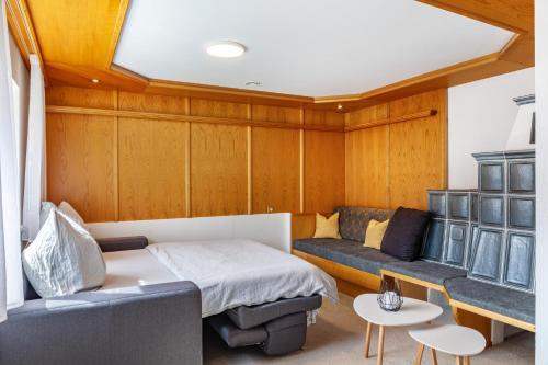 a small room with a bed and a couch at Ferienwohnung Pfeffer in Leogang