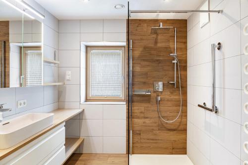 a bathroom with a shower and a sink at Ferienwohnung Pfeffer in Leogang