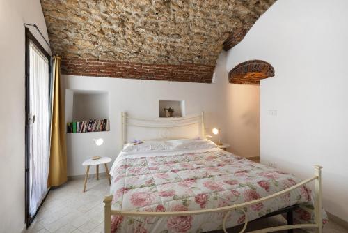 a bedroom with a bed and a brick ceiling at Ciliegio Agriturismo La Ferla in Toirano