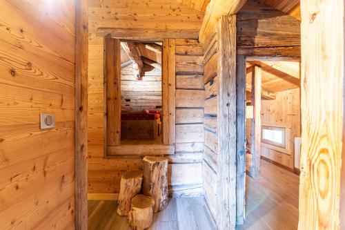 a room in a log cabin with a mirror at Gite Les Clapières in La Giettaz
