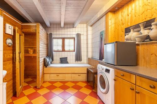 a kitchen with a washer and dryer in a room at Blockhaus Marie in Frielendorf