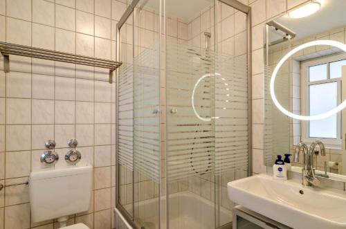 a bathroom with a shower and a sink at Ferienwohnung Boje 20 in Schillig