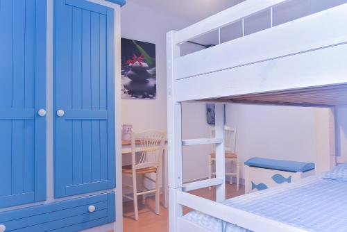 a bedroom with a bunk bed and a table at Gîte De La Voûte in Fécamp