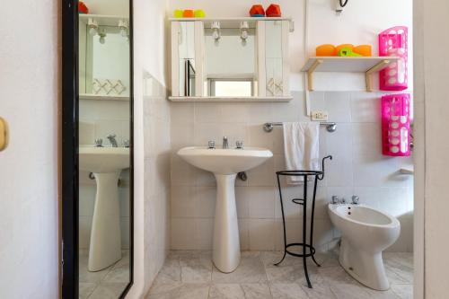 a bathroom with two sinks and a mirror at Trullo Nunuccio in Ceglie Messapica