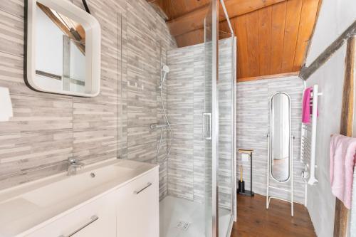 a bathroom with a shower and a sink at La maison blanche in Nazelles