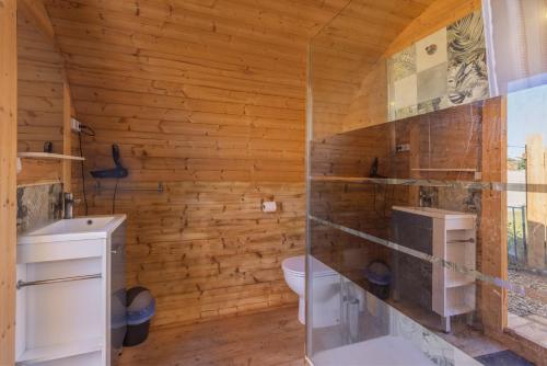 a bathroom with a toilet and a glass shower at Pink Pod in Saint-André