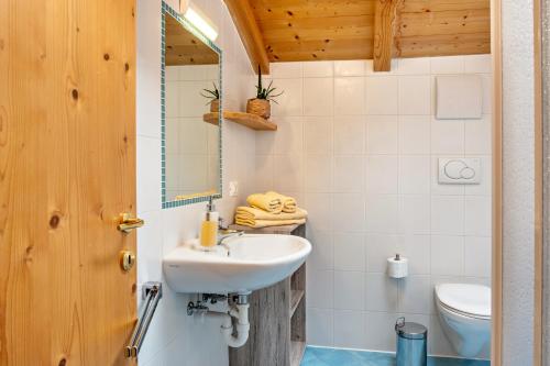 a bathroom with a sink and a toilet at Oberpatiglhof - Anna in Brie