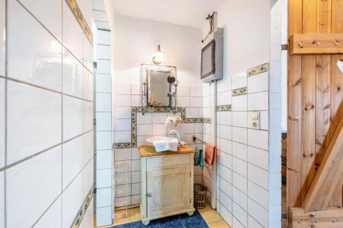 a bathroom with a sink and a mirror at Haus Deichgraf in Nordstrand