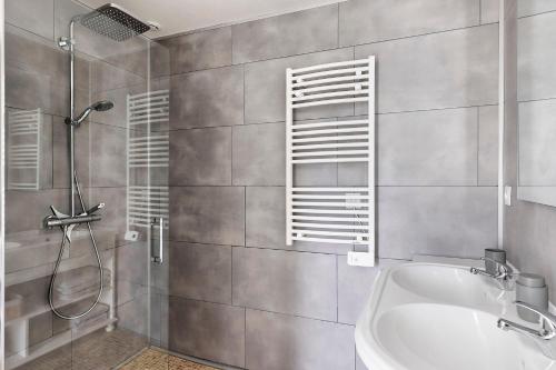 a bathroom with a shower and a tub and a sink at Gîte Du Parc in La Celle-Saint-Avant