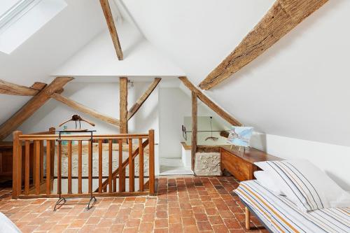a living room with a staircase and wooden beams at Gîte Du Parc in La Celle-Saint-Avant
