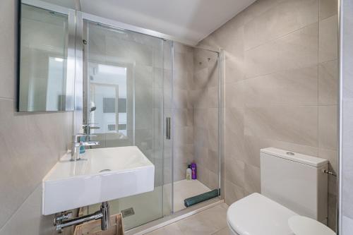 a bathroom with a toilet and a sink and a shower at Bonanova 20 in Palma de Mallorca