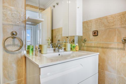 a bathroom with a white sink and a mirror at Calpe Vistas y Playa in Calpe