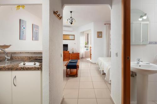 a bathroom with a sink and a room with beds at Estudio Bloque 84 in Torrox