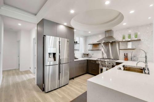 a large kitchen with a stainless steel refrigerator at 3BR recently renovated SOMA flat in San Francisco