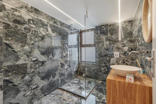 a bathroom with a sink and a shower at Luxsuites in Chania