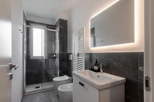 a bathroom with a sink and a toilet and a mirror at Blueyes House Tuscany in Artimino