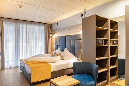 a hotel room with a bed and a chair at Ferienwohnung Hirsch-Loge in Pflach