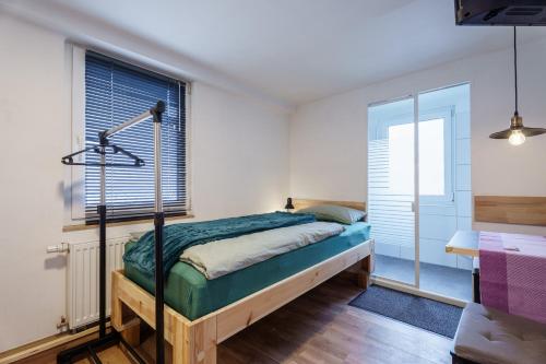 a bedroom with a bed and a window at Haus Hauptstrasse 23a in Bühl