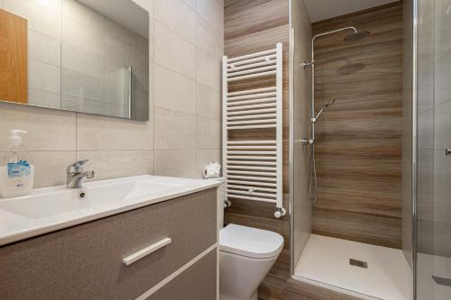 a bathroom with a toilet and a sink and a shower at 4 Terraza - Antilles sin jardin in Llanes