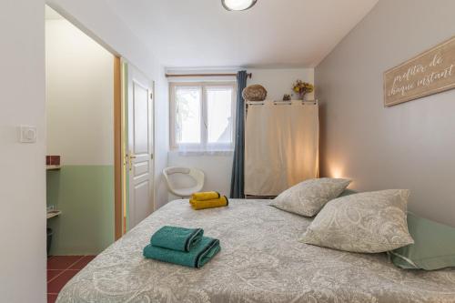 a bedroom with a bed with two towels on it at La Dolce Vita in Lambesc