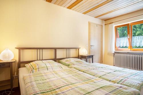 a bedroom with two beds and a window at Marie in Weiler-Simmerberg