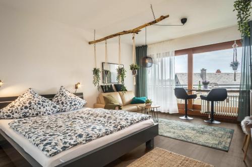 a bedroom with a bed and a living room at Heimelig im Hirschen App 240 in Schönwald