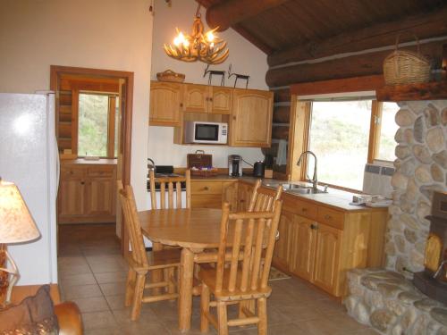 a kitchen with a wooden table and a dining room at Rye Creek Lodge in Darby