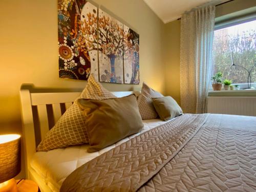 a bedroom with a bed with pillows and a window at Ferienwohnung an der Schlei in Fleckeby