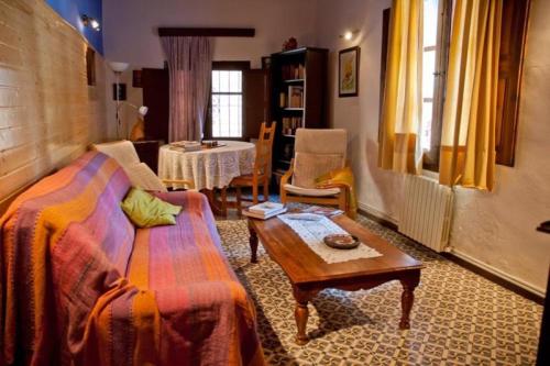 a living room with a couch and a table at Casa Jara in Azuara