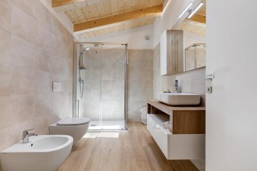 a bathroom with a shower toilet and a sink at Jacky's Apartments in Limone sul Garda