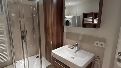 a bathroom with a sink and a shower at Traumhaus mit herrlichem Graz Blick in Graz