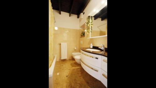 a bathroom with a toilet and a sink at Gorgeous 1 double bedroom apartment in Bellagio