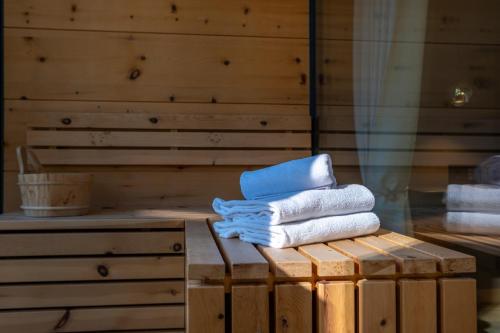 a stack of towels sitting on top of a wooden box at Levita Living Freiheit in Tirolo
