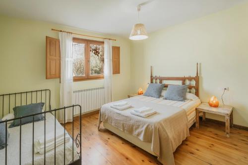 a bedroom with a large bed and a window at La Alameda in Marazuela