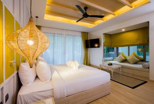a bedroom with a bed and a living room at Mandarava Resort and Spa, Karon Beach in Karon Beach