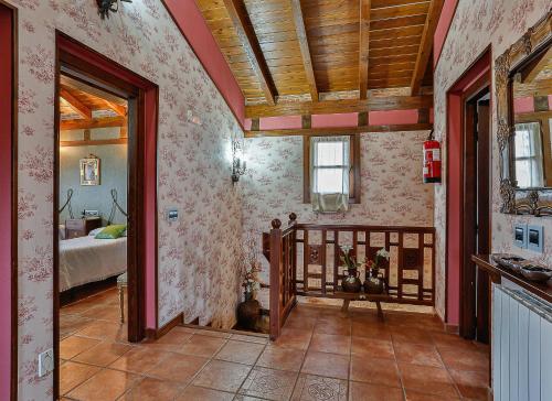a room with a bedroom with a bed and a doorway at El Lagar in Canalejas de Peñafiel