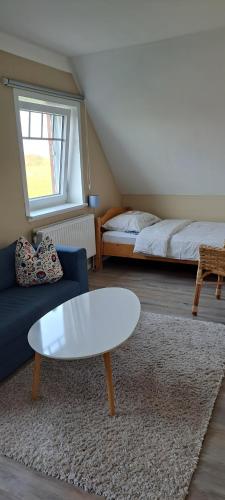 a living room with a couch and a coffee table at Fewo Sandbank in Pellworm