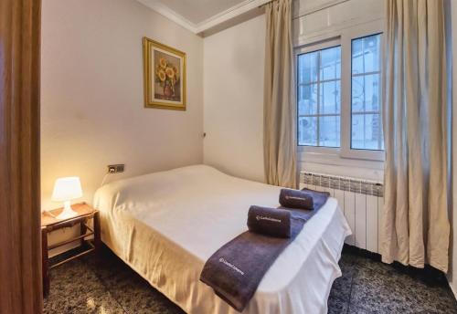 a bedroom with a bed and a window at Costacabana - Villa Rosa in Lloret de Mar