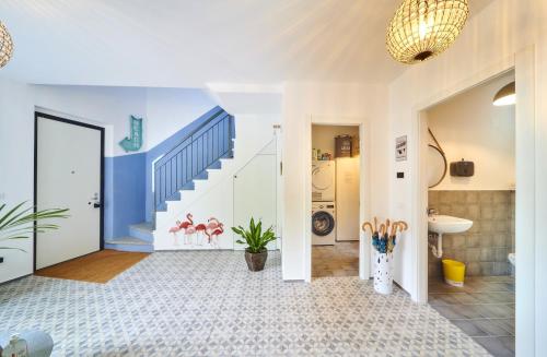 a hallway with a staircase in a house at Casa Royale Appartamento Aria in Lierna