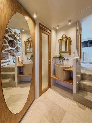 a bathroom with two sinks and a mirror at Alegria Mykonos 7 Suites in Kalafatis