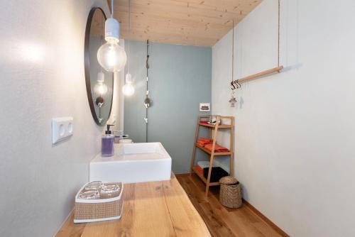 a bathroom with a white sink and a mirror at Ferienwohnung am Stadtwald in Triberg