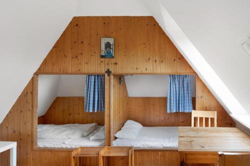 a bedroom with two bunk beds in a house at Haus Deichgraf in Nordstrand