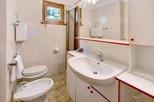 a bathroom with a sink and a toilet at Chalet Holly in Bormio