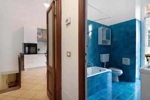 a blue bathroom with a tub and a toilet at Levanto A 50 Metri dal Mare in Levanto