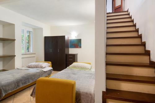 a bedroom with two beds and a staircase at Levanto A 50 Metri dal Mare in Levanto
