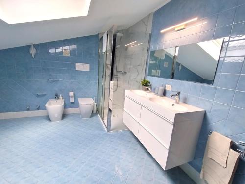 a bathroom with a toilet and a sink and a shower at Royal Residence Abano Terme in Abano Terme