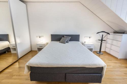 a bedroom with a large bed with two night stands at am Salinensee in Bad Dürrheim