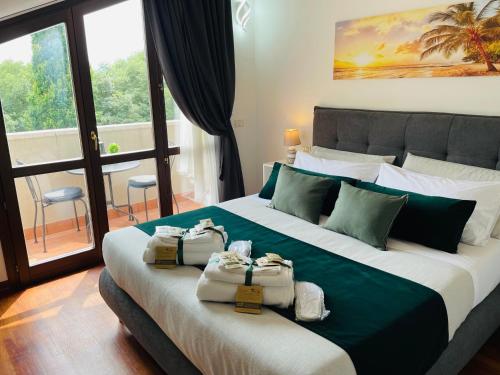 a hotel room with a large bed with bags on it at Royal Residence Abano Terme in Abano Terme