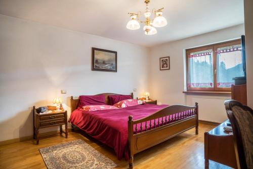 a bedroom with a large bed and a window at Villa Fiore in Lamon