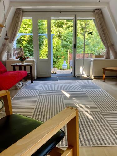 a living room with a large sliding glass door at Ferienhaus am Waldrand in Billerbeck